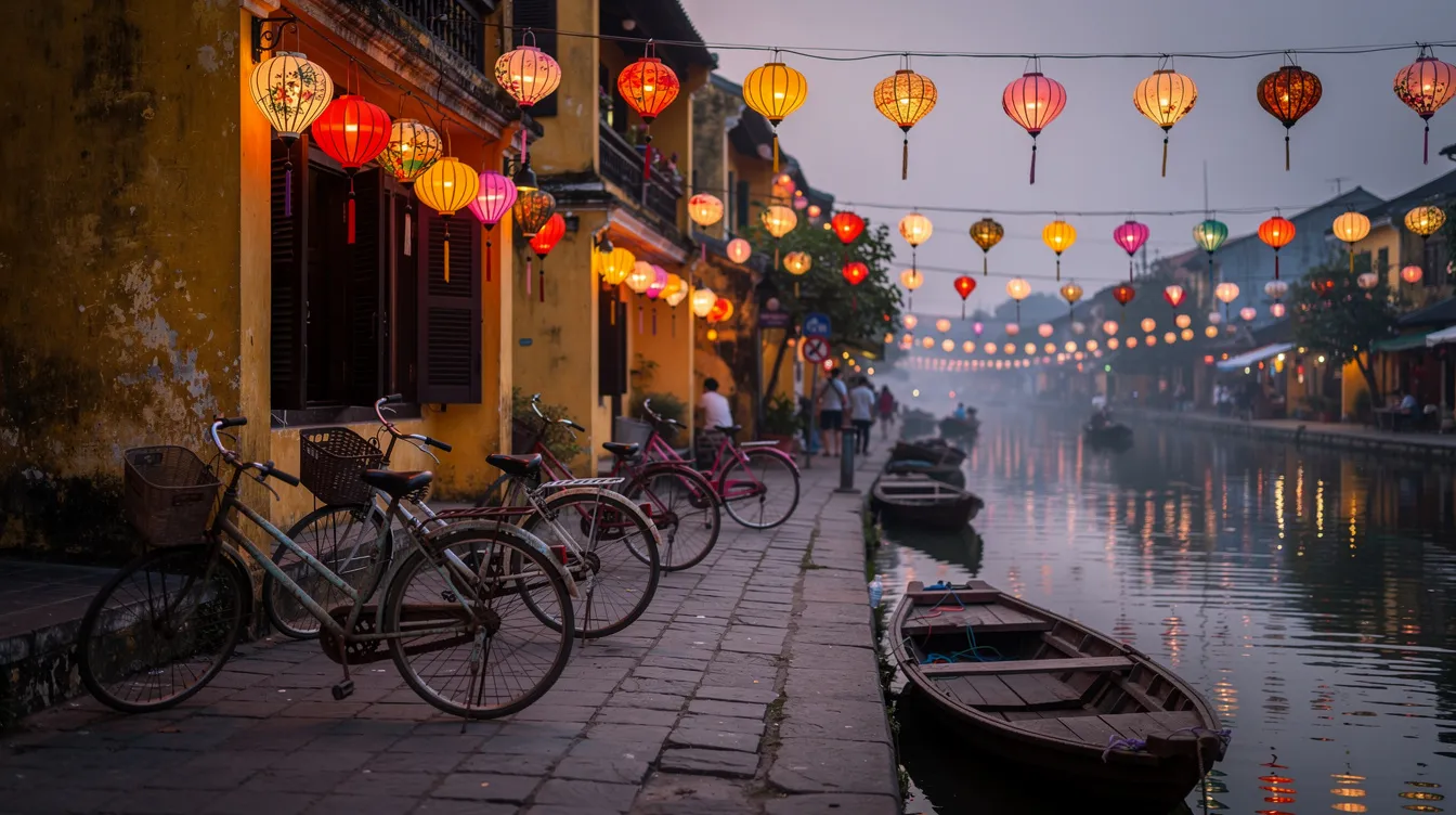 The image depicts vibrant lanterns glowing softly at dusk along a serene canal in Hoi An's ancient town, with bicycles parked beside the water, creating a picturesque scene that captures the charm of this UNESCO World Heritage site. The warm lights reflect on the water, enhancing the romantic atmosphere of the historic streets.